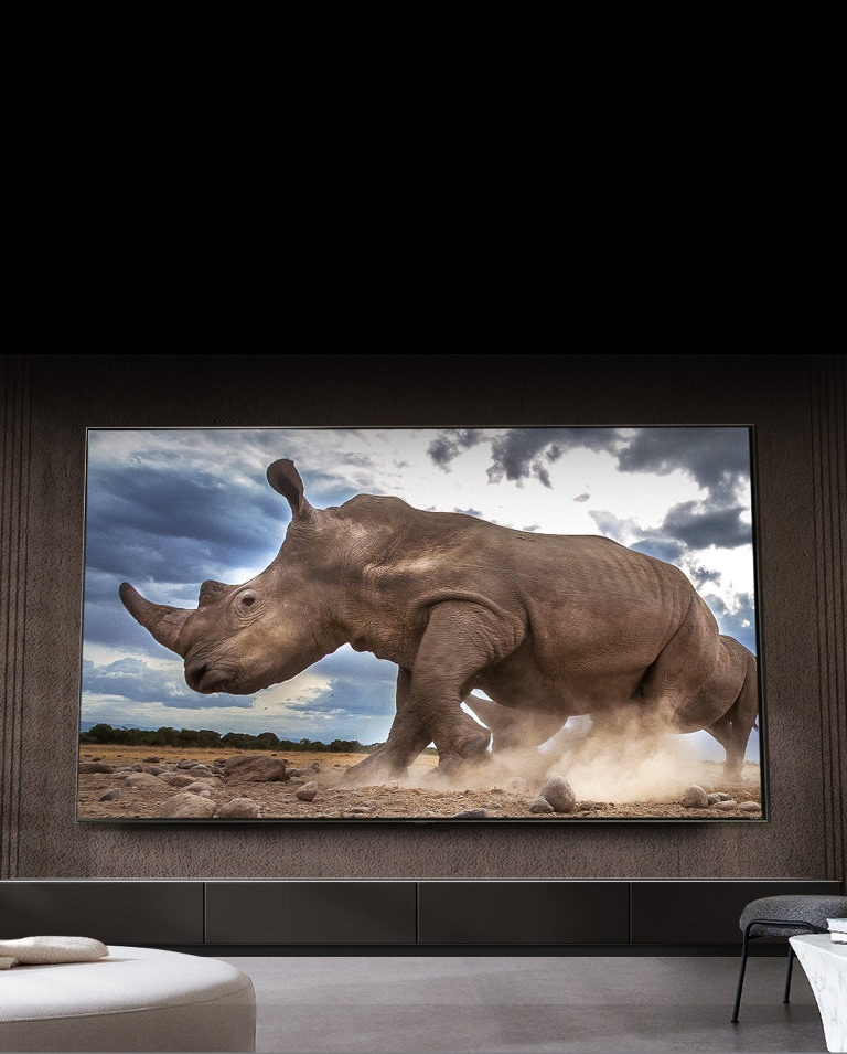 A UHD TV mount on wall behind a tabe with zen style setting.