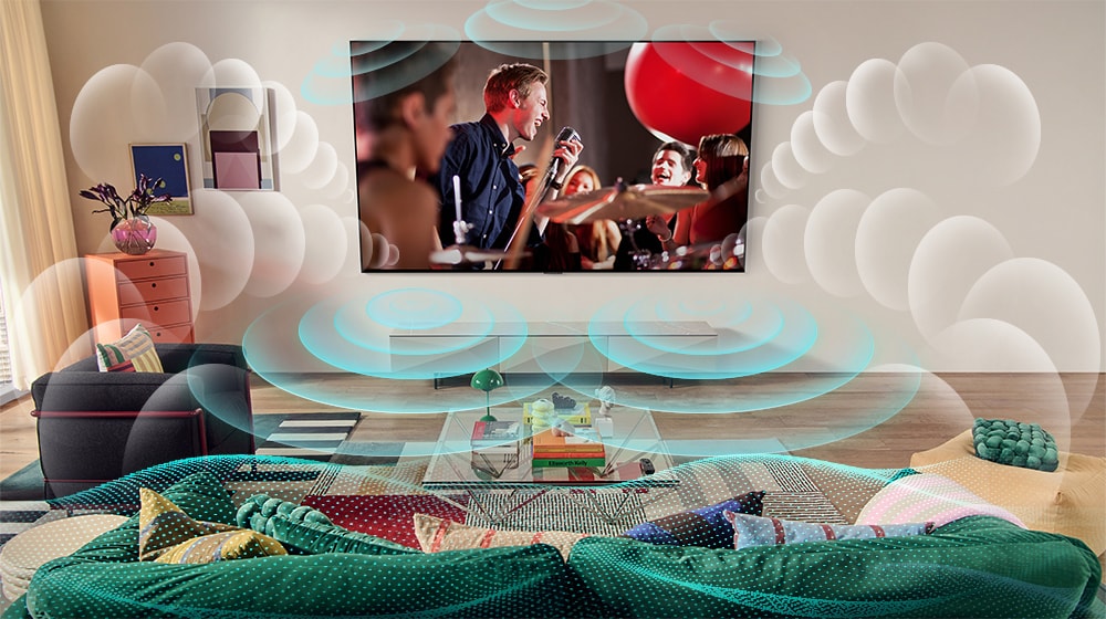 Una imagen de un televisor LG OLED en una sala que muestra un concierto de música. Burbujas que representan sonido envolvente virtual llenan el espacio.