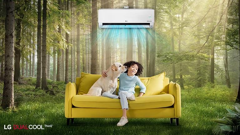 Children and pets are happy sitting on the couch in the forest, enjoying the air conditioning wind like natural wind.