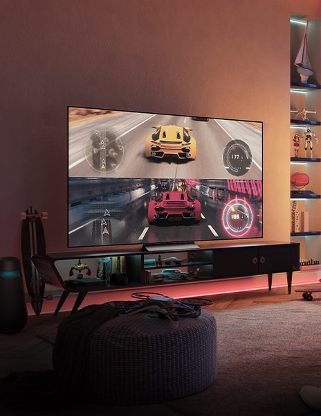 Un televisor con una pantalla de juego encendida está colocado en un espacio interior oscuro.