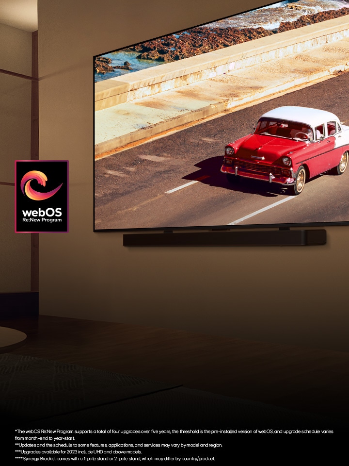 LG QNED TV and Soundbar mounted on a wall in a softly lit room. On the TV, a red vehicle on the road is displayed. The "webOS Re:New Program" logo is in the image. A disclaimer reads: "The webOS Re:New Program supports a total of four upgrades over five years, the threshold is the pre-installed version of webOS, and upgrade schedule varies from month-end to year-start." "Updates and the schedule to some features, applications, and services may vary by model and region." "Synergy Bracket comes with a 1-pole stand or 2-pole stand, which may differ by country/product."