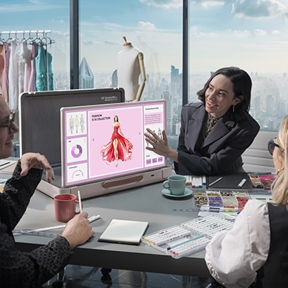 StanbyME Go is placed in the meeting room in office. The screen shows a fashion presentation. A woman touches the screen.
