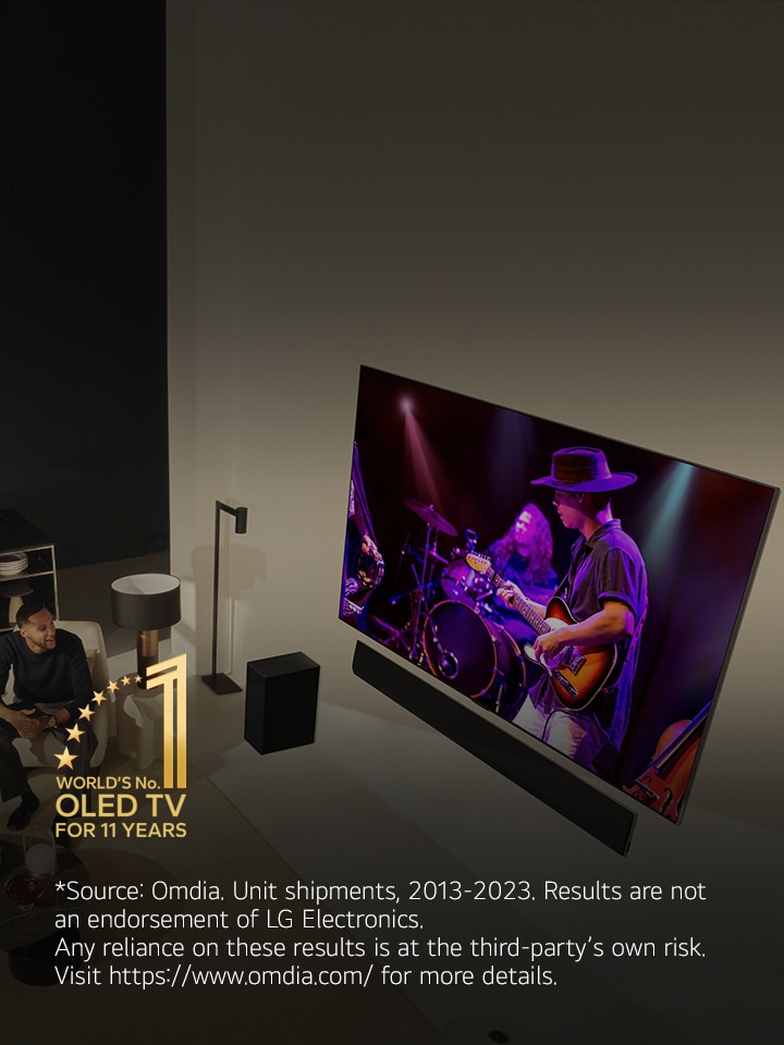 An overhead perspective of a man and woman watching a concert on a large OLED TV in a modern apartment. The "World's number 1 OLED TV for 11 Years" emblem is in the image. A disclaimer reads: "Source: Omdia. Unit shipments, 2013 to 2023. Results are not an endorsement of LG Electronics. Any reliance on these results is at the third party’s own risk. Visit https://www.omdia.com/ for more details."