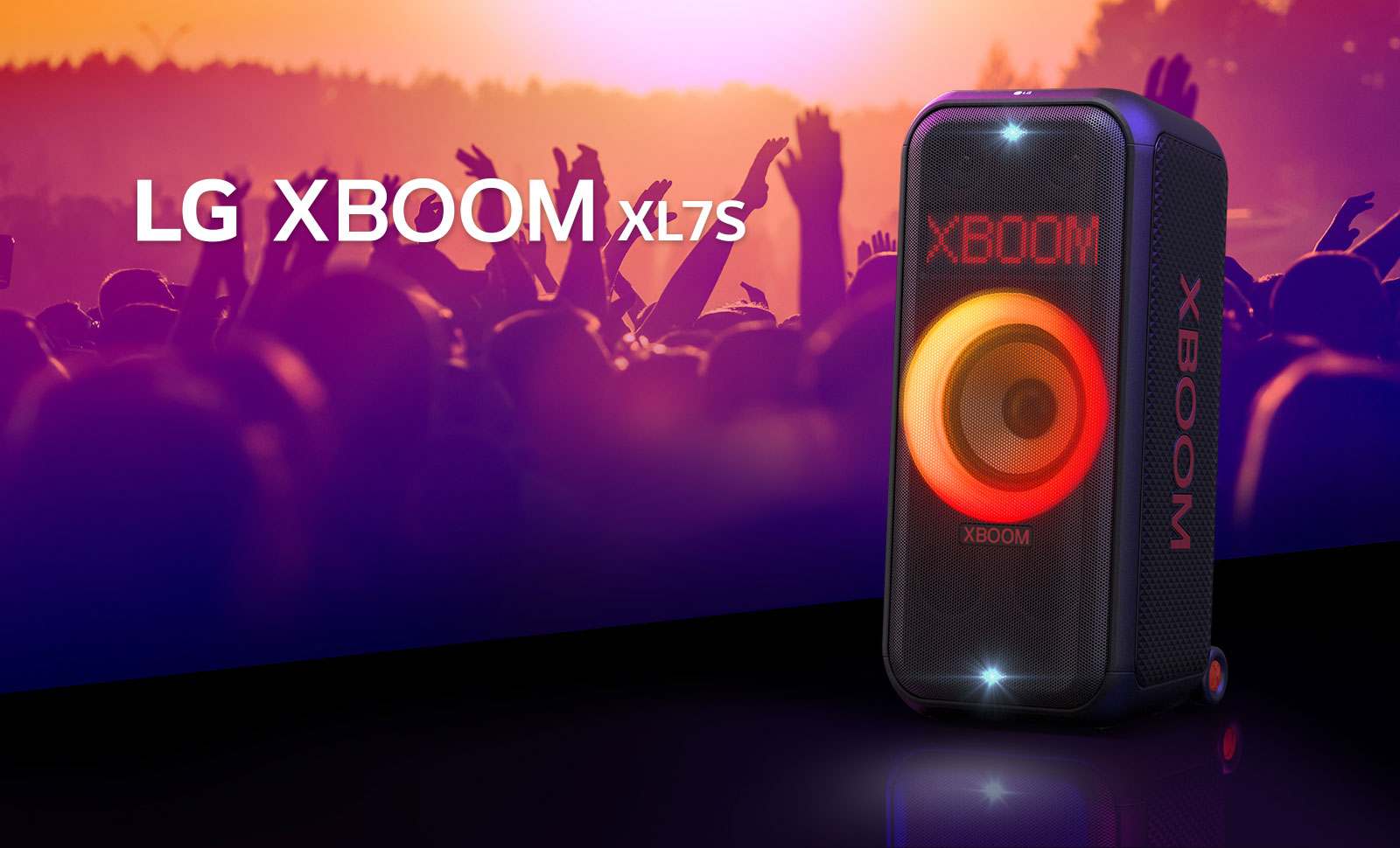 LG XBOOM XL7S được đặt trên sân khấu với đèn chuyển màu từ đỏ sang cam đang sáng. Phía sau sân khấu, mọi người đang thưởng thức âm nhạc.