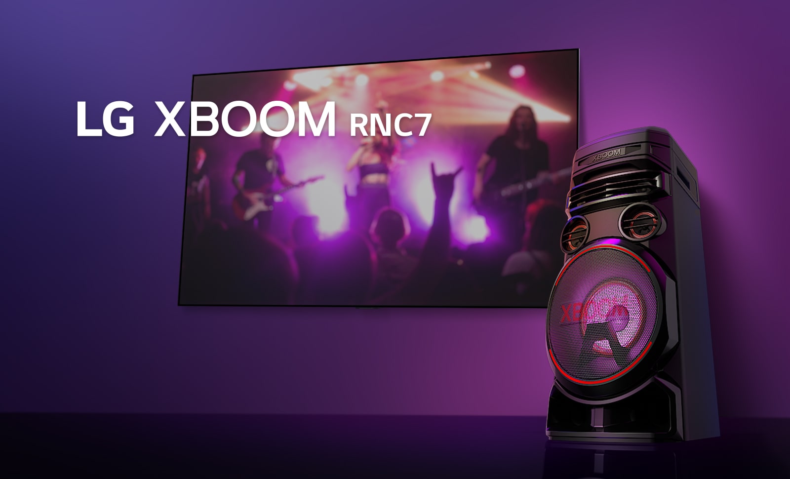 A low angle view of the right side of LG XBOOM rnc7 against a purple background. The XBOOM light are also purple. And a TV screen displays a concert scene.